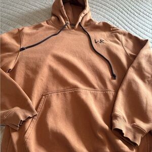 Brown Pullover Hoodie with Drawstring and Minimalist Logo